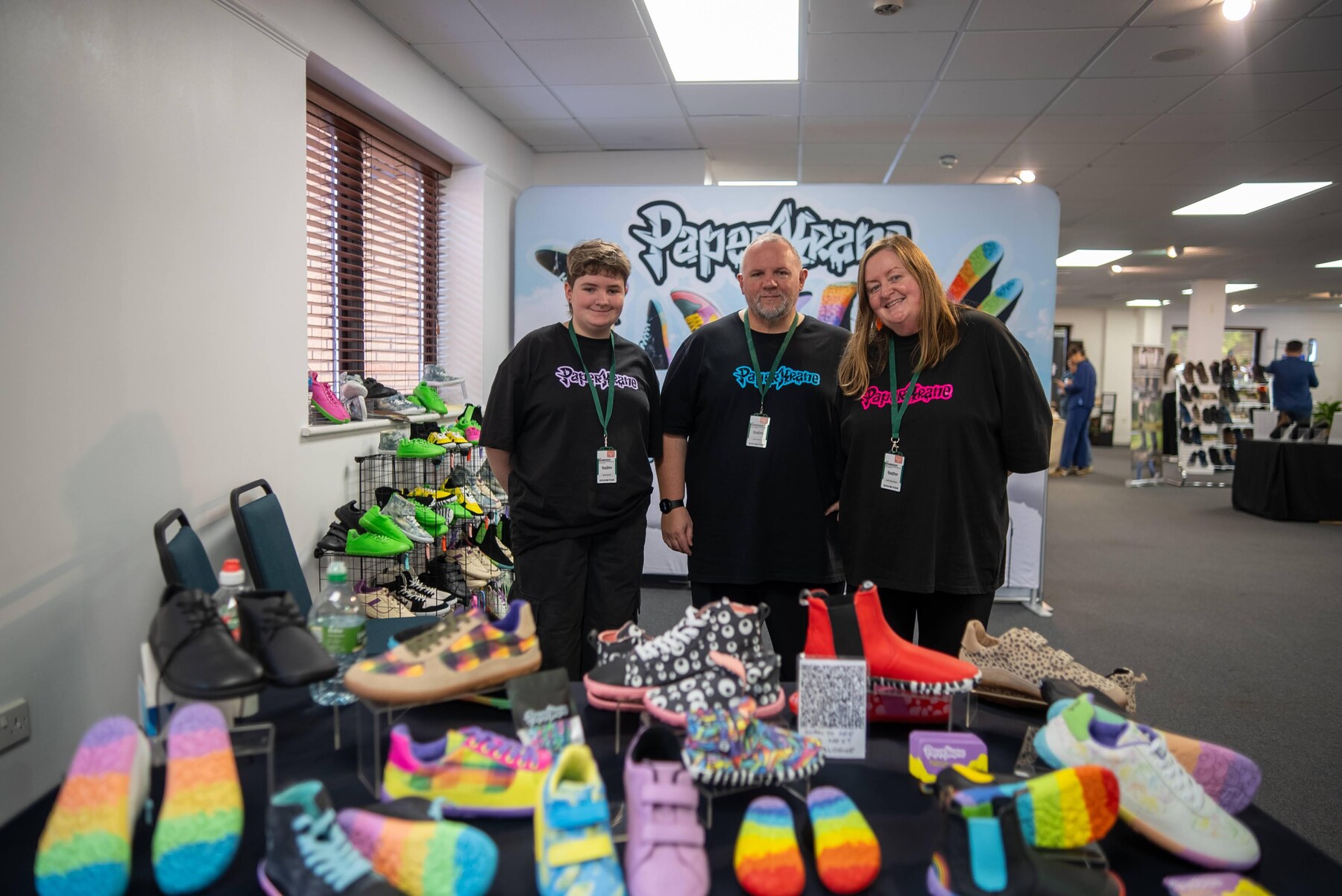 The Paperkrane team with colourful barefoot shoes on display, photo by Barefoot Brit Expo