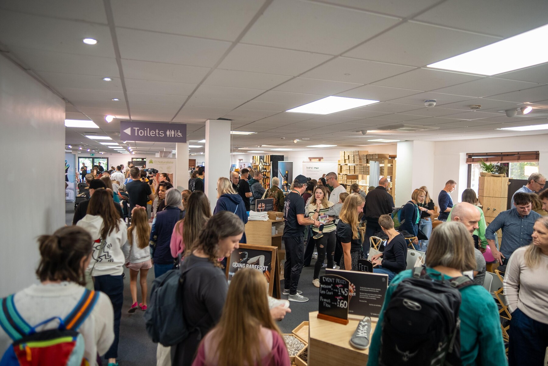 Visitors browsing the busy exhibition hall at Cranmore Park, photo by Barefoot Brit Expo
