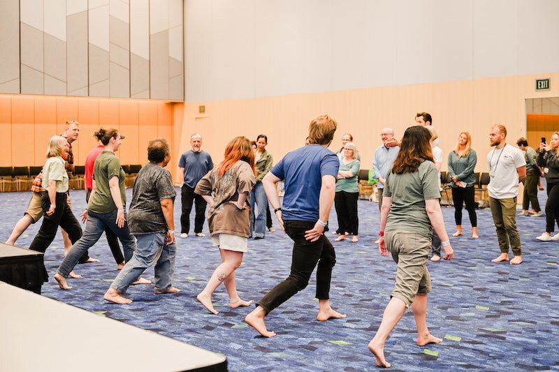 Workshop participants practising walking together, photo by Barefoot Shoe Expo
